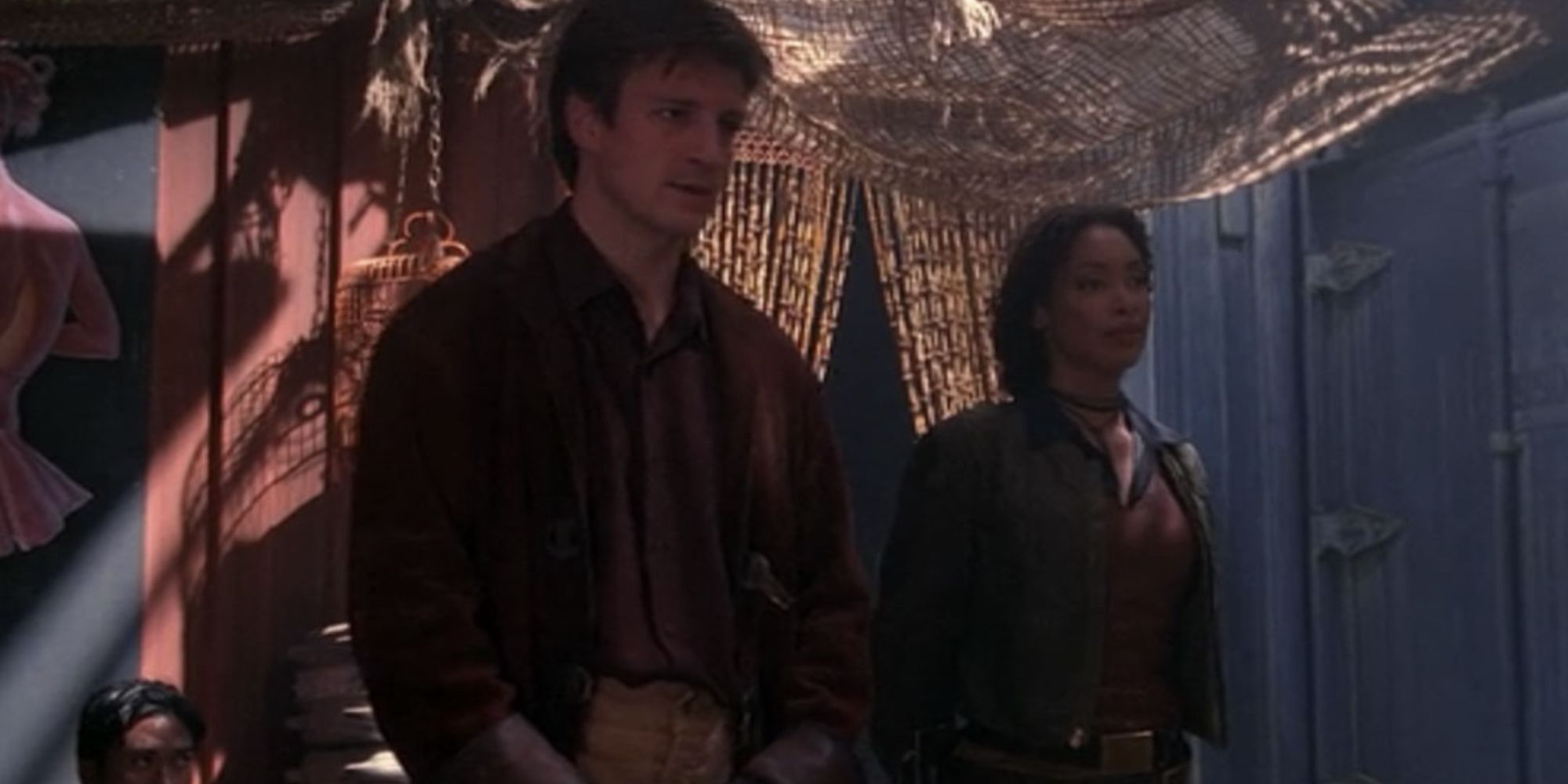 Nathan Fillion and Gina Torres as malcolm reynolds and zoe washburne speaking to someone