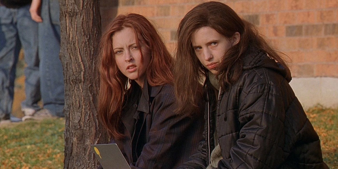 Two teen girls stand next to each other