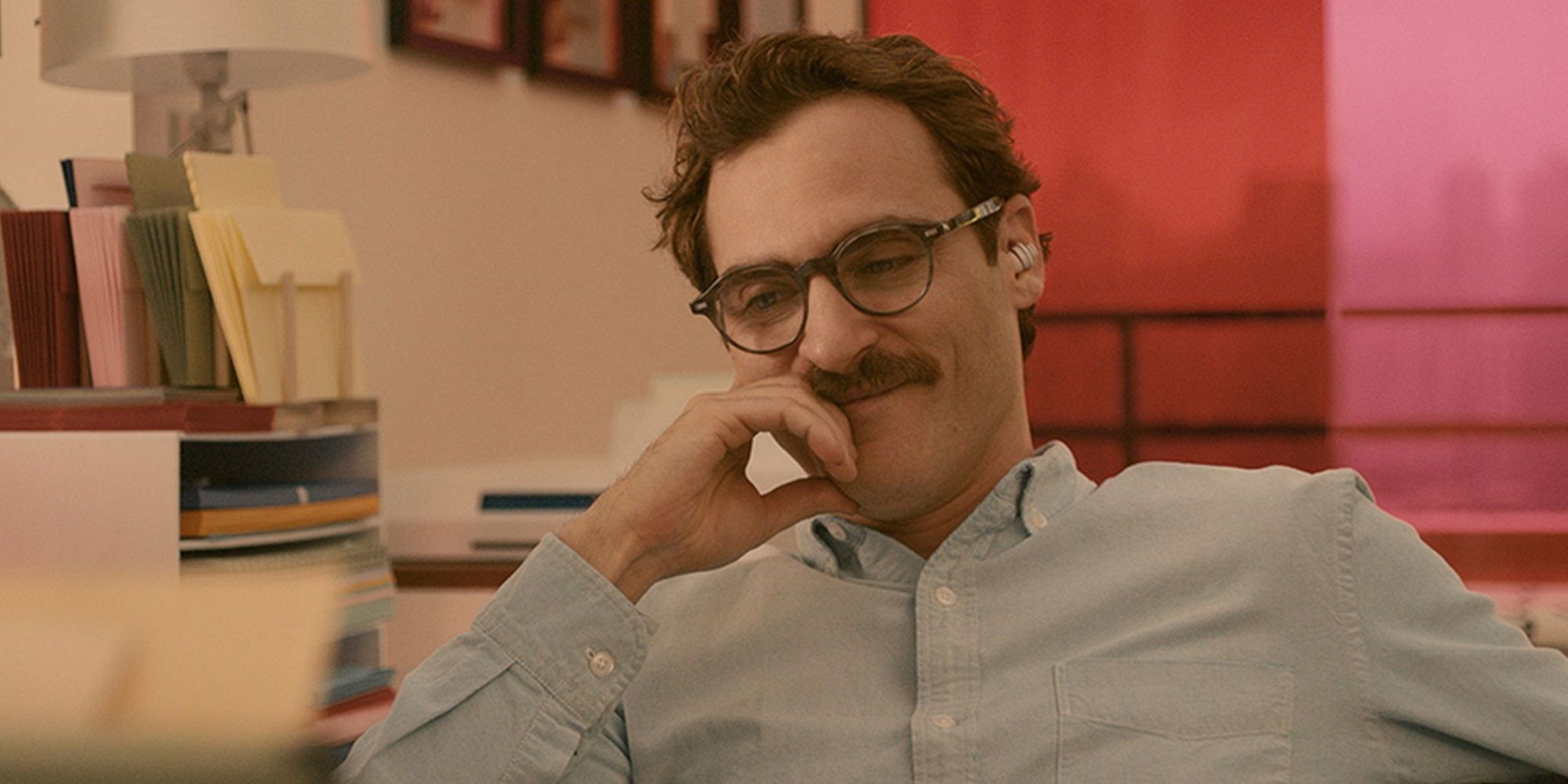 A close-up shot of Joaquin Phoenix as Theodore smiling in 'Her.'