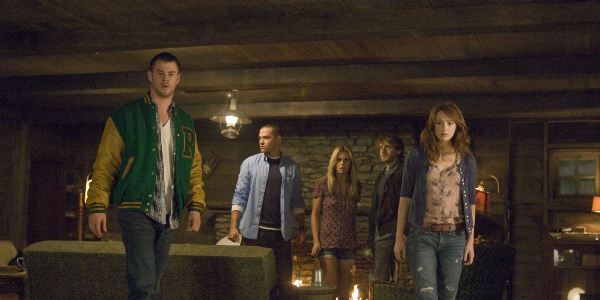 A group of young people in a cabin looking confused