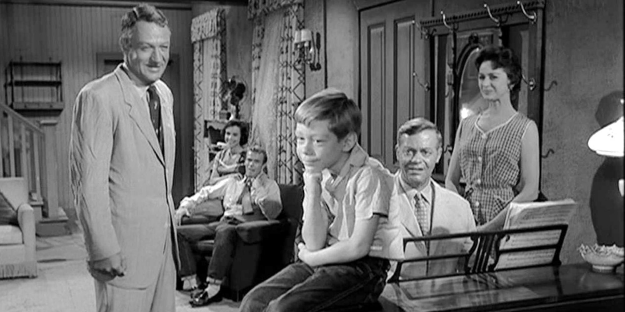Black and white image of a family sitting in the living room in The Twilight Zone