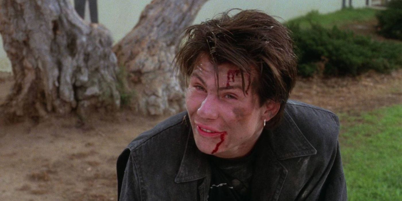 Christian Slater as J.D. in Heathers looking roughed up and bloodied