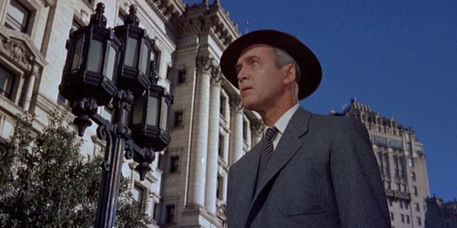 John Ferguson (James Stewart) standing on the street and looking on in 'Vertigo'