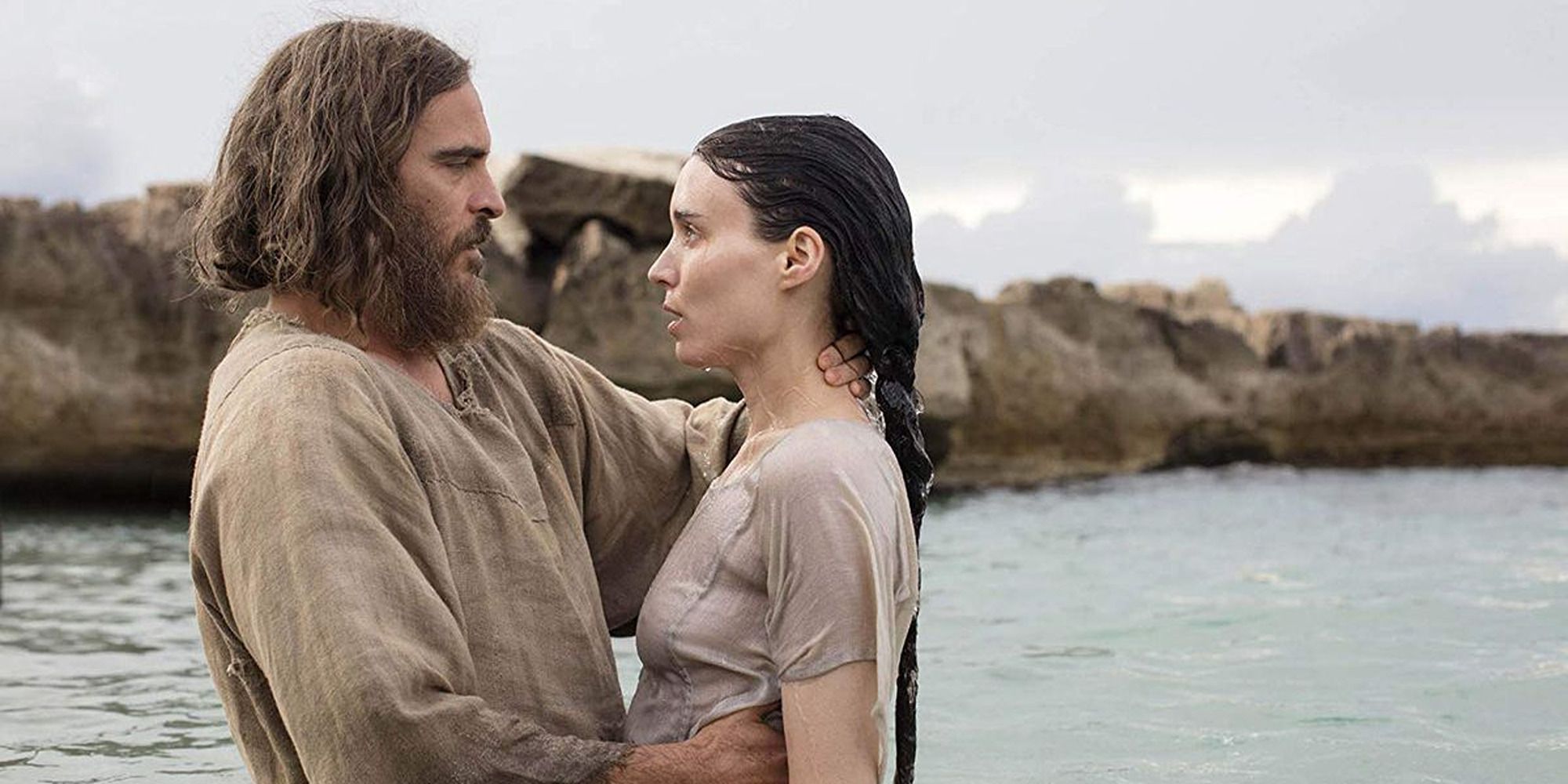 Joaquin Phoenix baptizing Rooney Mara in a river