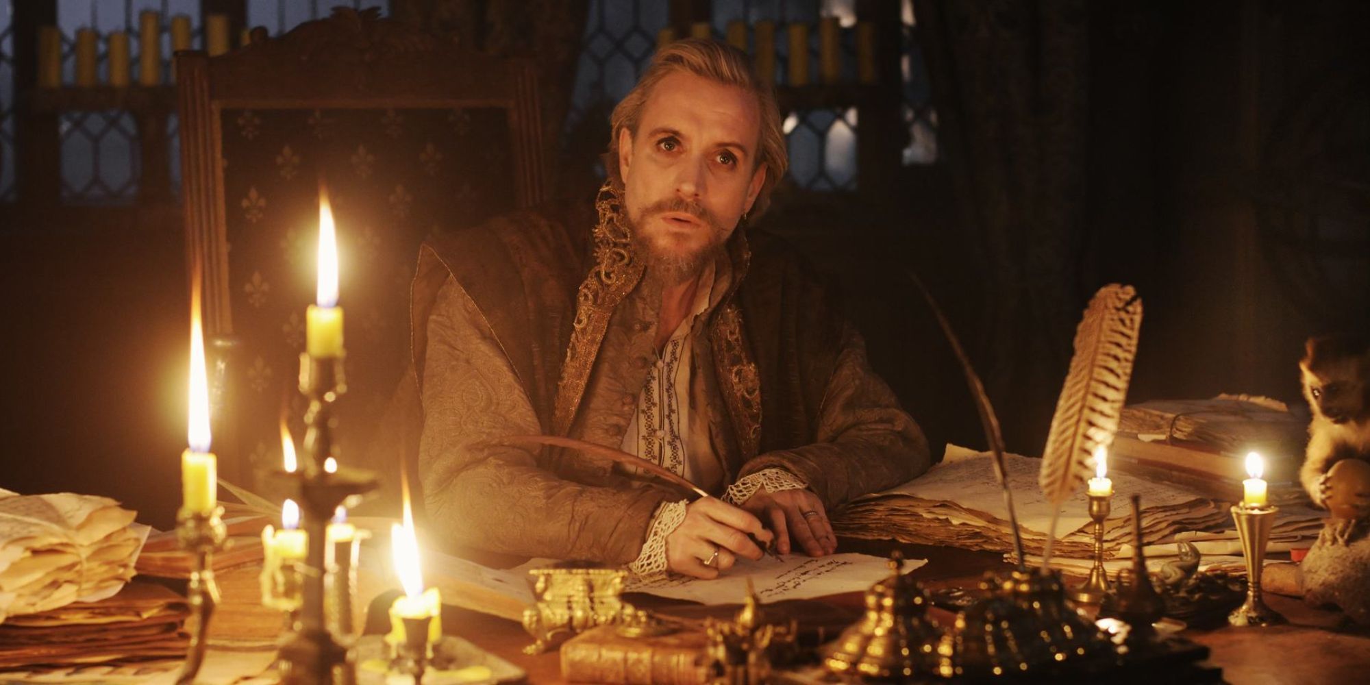 A man in period costume is writing