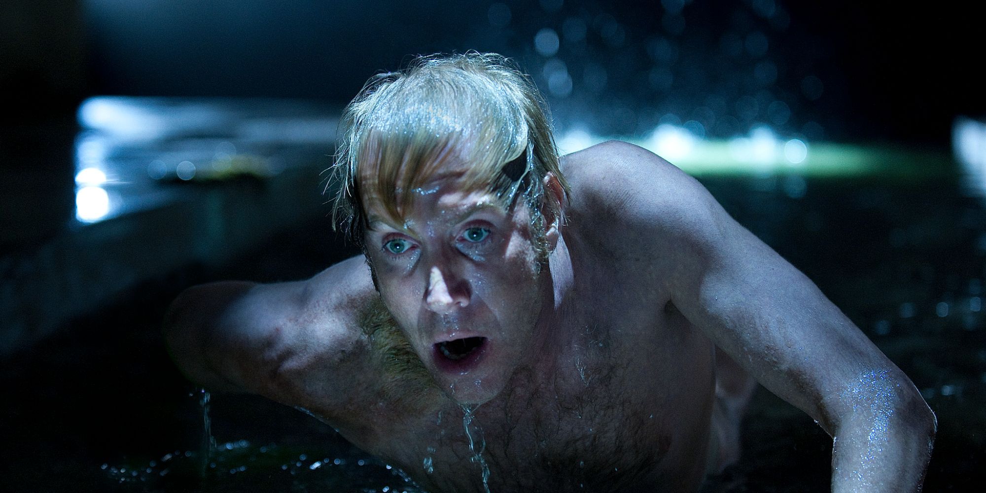 a man crawling out of the water