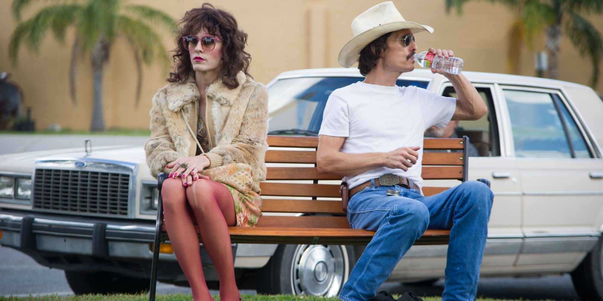 A man and a woman sitting on a park bench