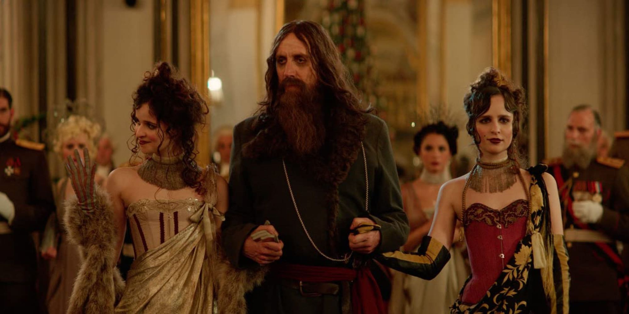 A man is accompanied by two women at a party
