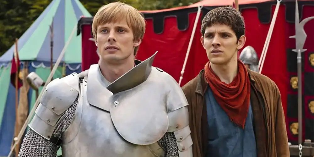 Bradley James and Colin Morgan as Merlin and Arthur standing together in Merlin.