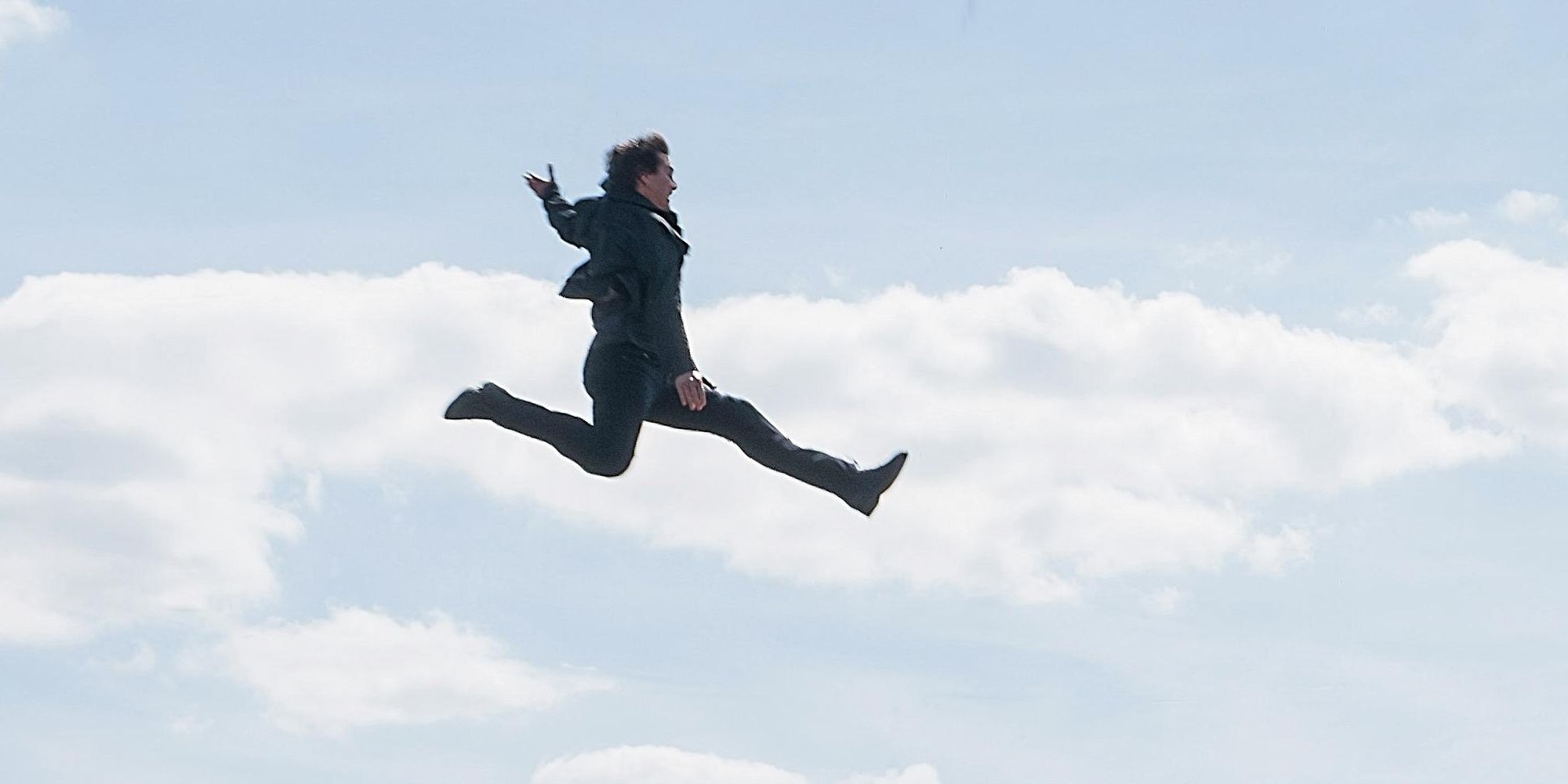 Ethan Hunt (Tom Cruise) air-jumps from one building to another.
