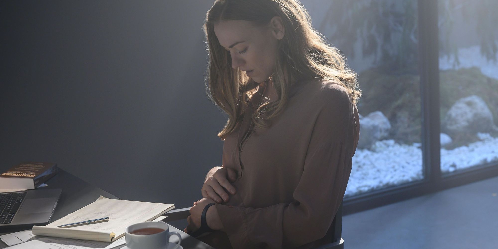 Serena Joy holding her stomach