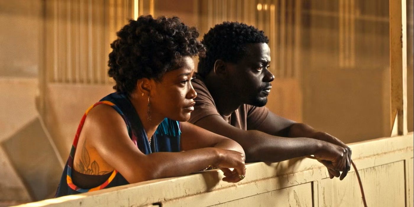 A woman and man stand watching in a barn