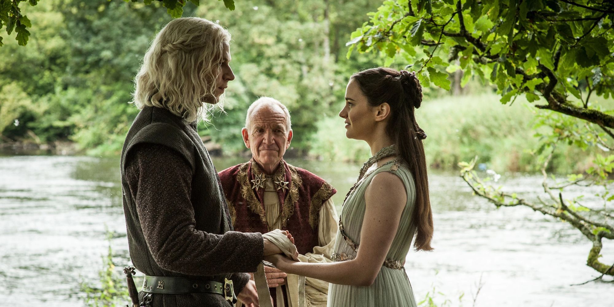 Rhaegar (Wilf Scolding) and Lyanna (Aisling Franciosi) hold hands as they get married in 'Game of Thrones'