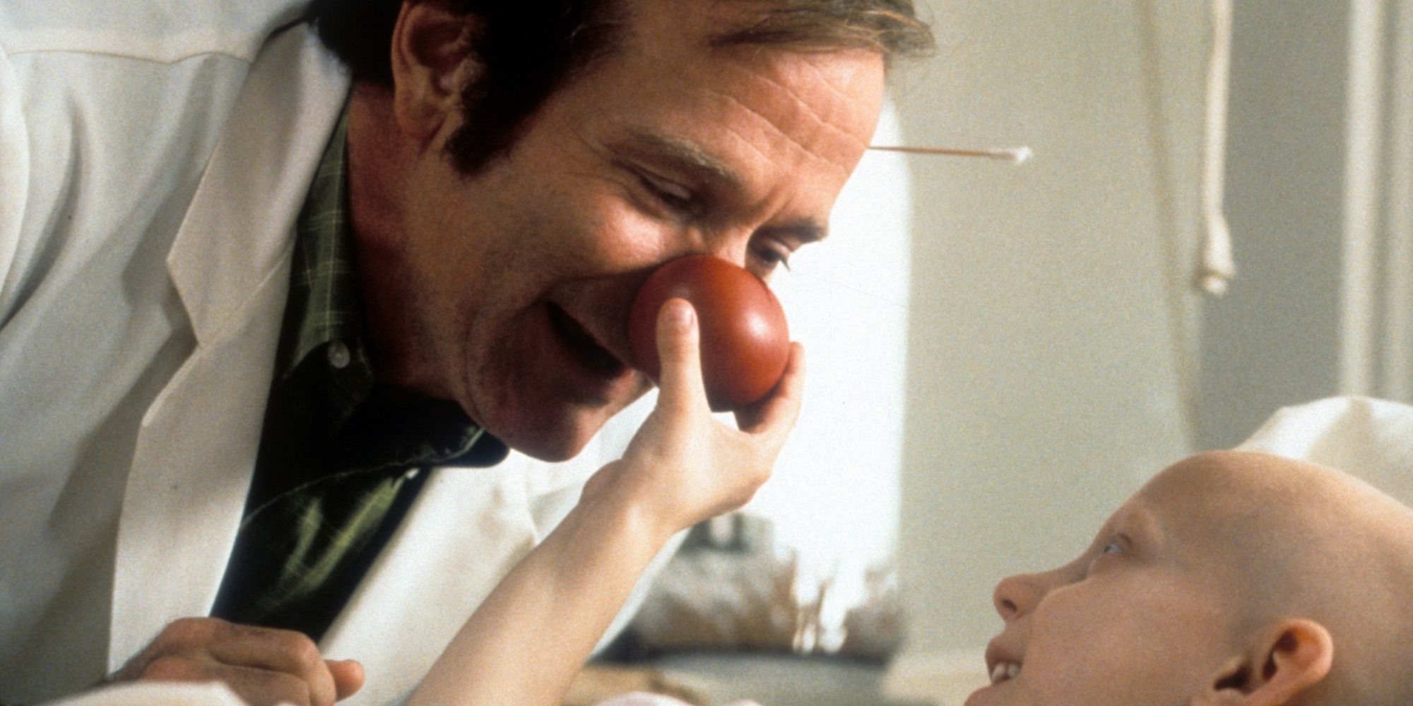 A sick child squeezing Patch Adam's clown nose in Patch Adams.