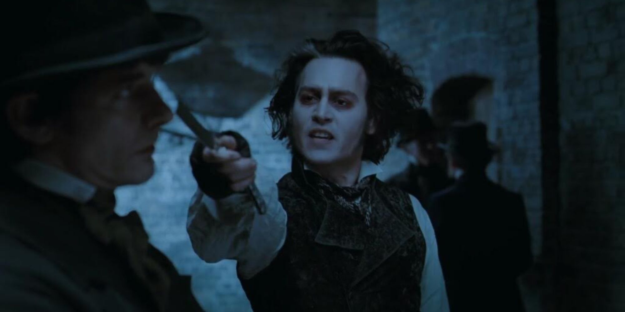 Johnny Depp as Sweeney Todd holding his razor to a man's face