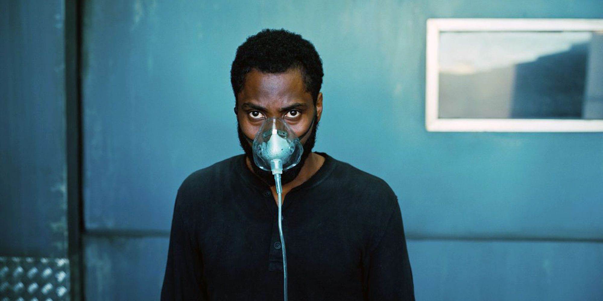 John David Washington as the Protagonist wearing a gas mask in Tenet