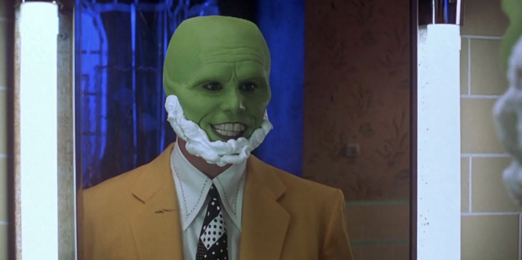 Man with a green mask standing in front of a mirror in 'The Mask'