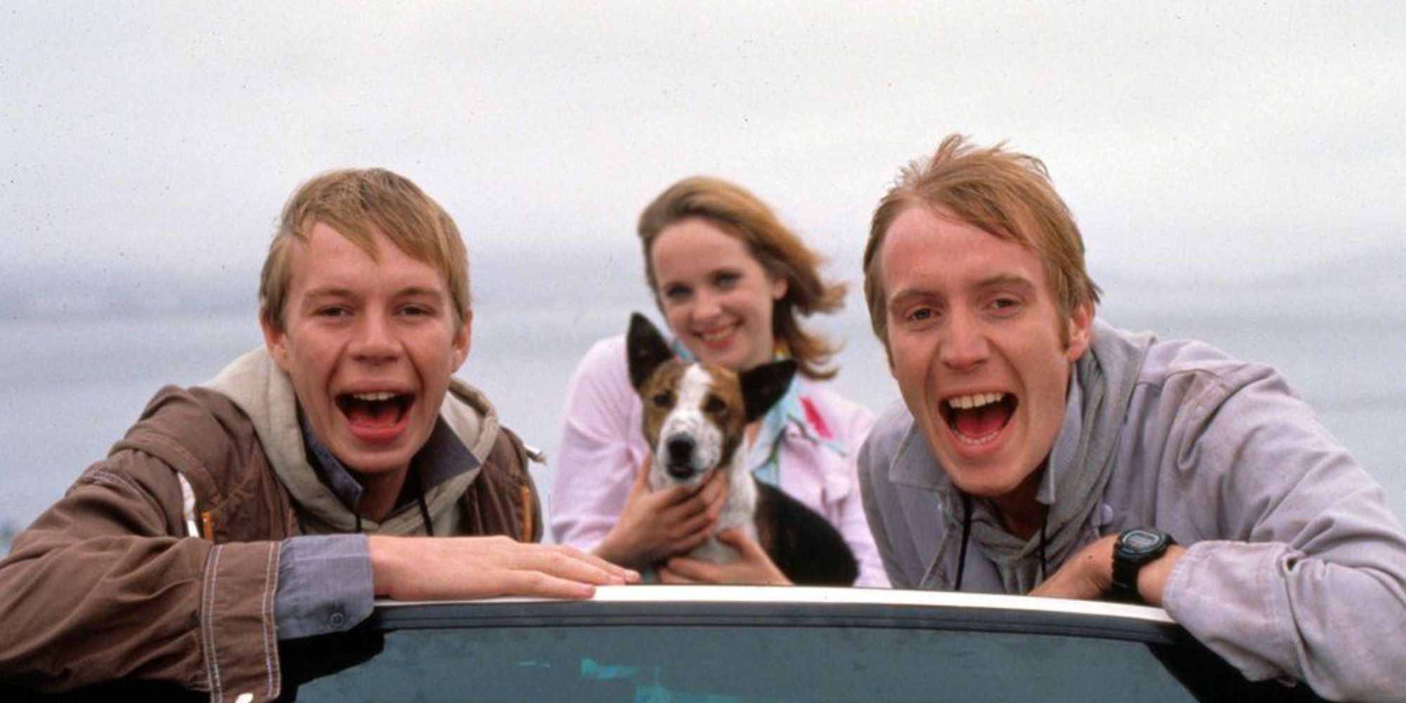 three people laughing and posing for a picture