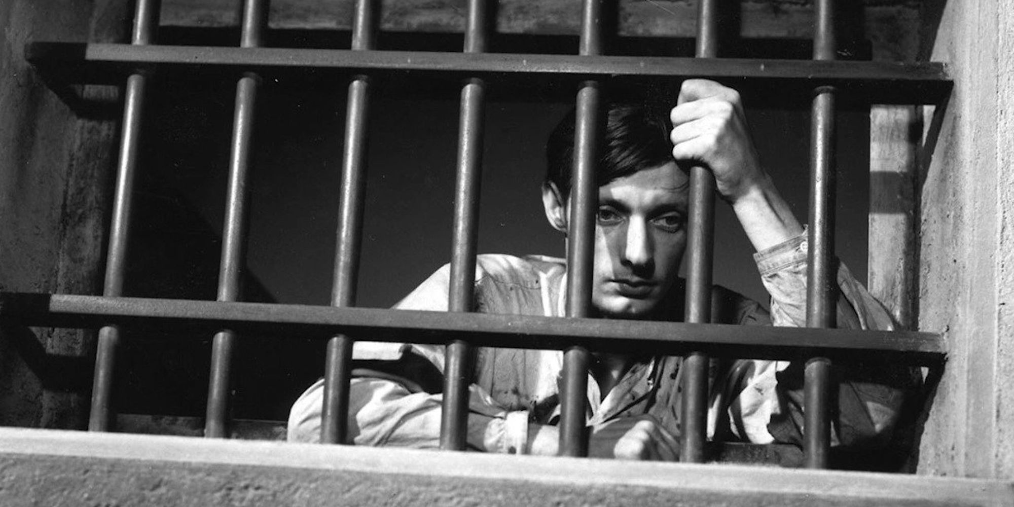 François Leterrier as Lieutenant Fontaine, looking sadly through prison bars in A Man Escaped