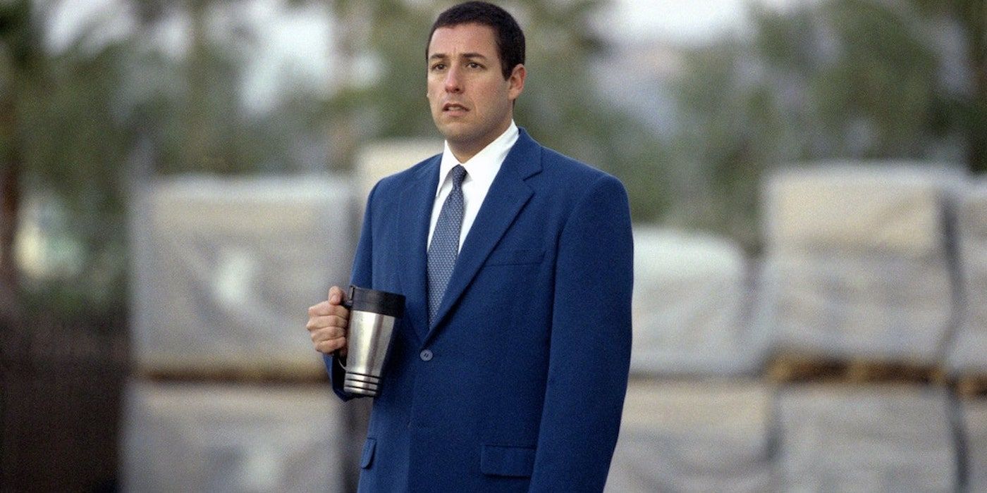 Barry Egan standing still and looking to the distance while holding a thermos in Punch-Drunk Love.