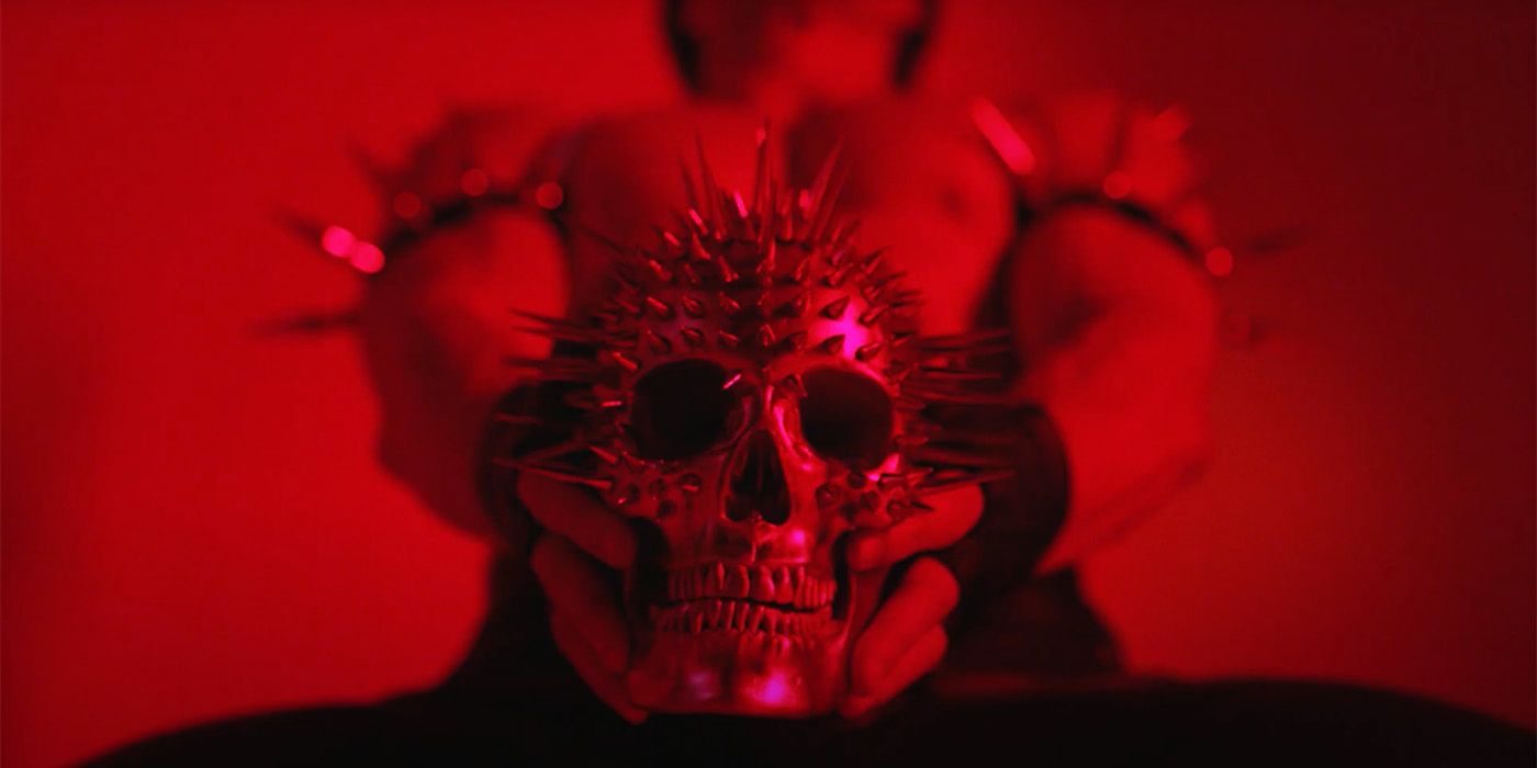 Leather man holding spiked skull in American Horror Story: NYC