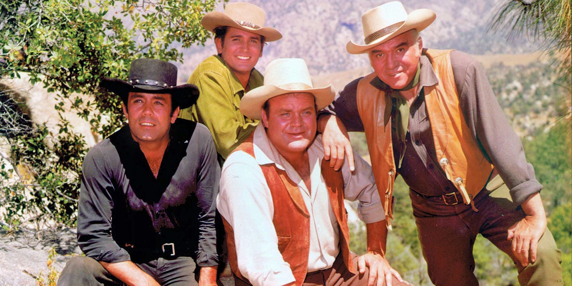 The cast of Bonanza posing, all wearing cowboy hats.