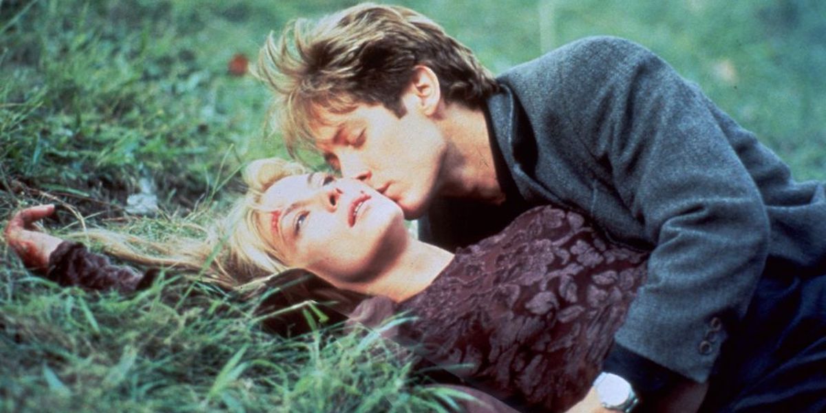 James and Catherine lying on the grass in Crash.