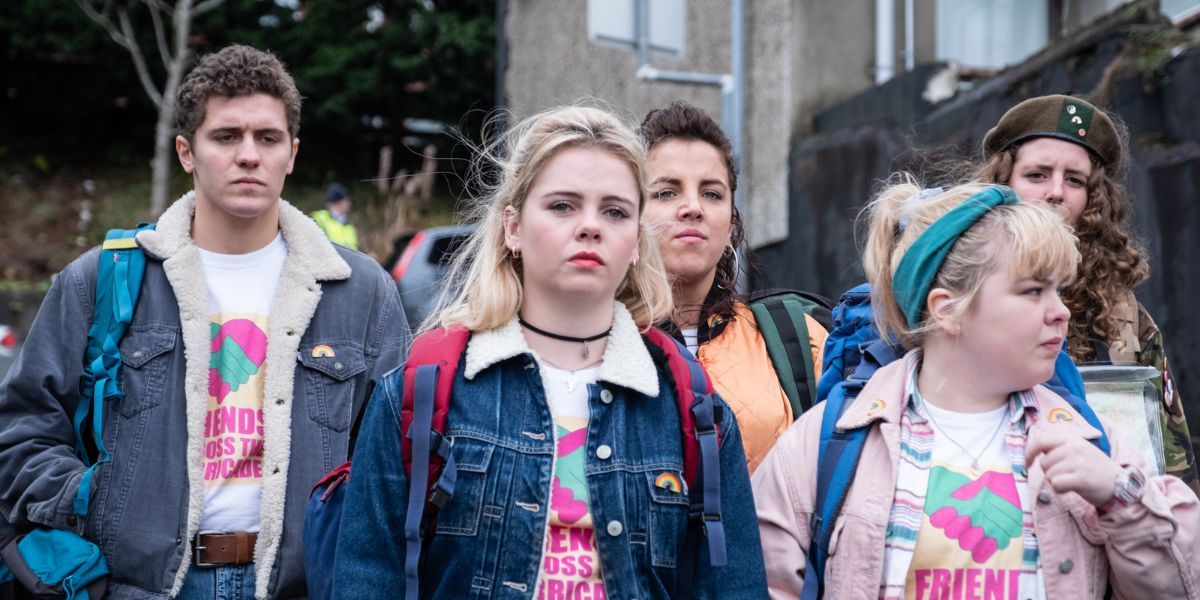 Several characters from Derry Girls standing with jean jackets and backpacks.
