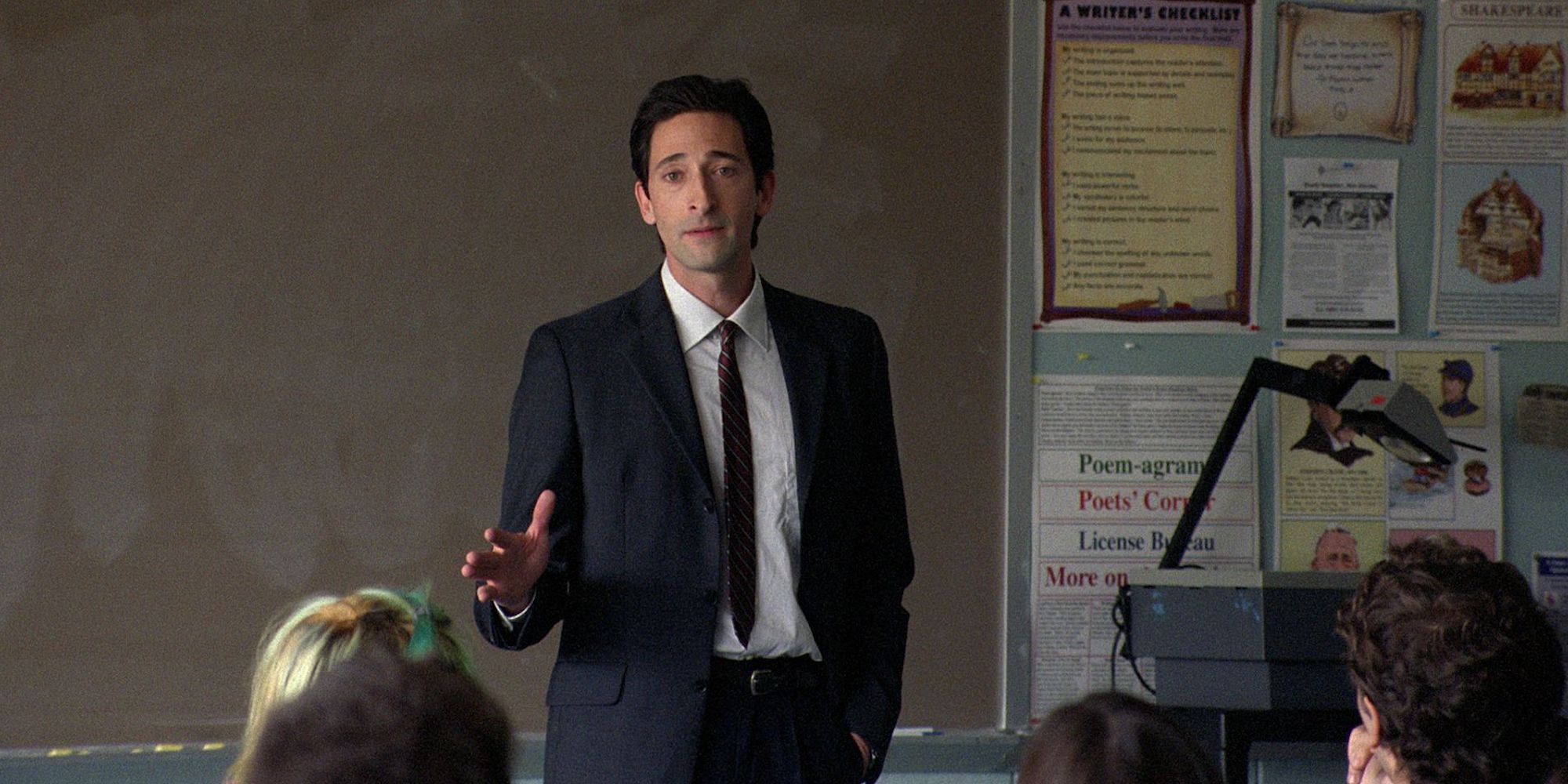 Adrien Brody stands in front of a classroom with students in Detachment.