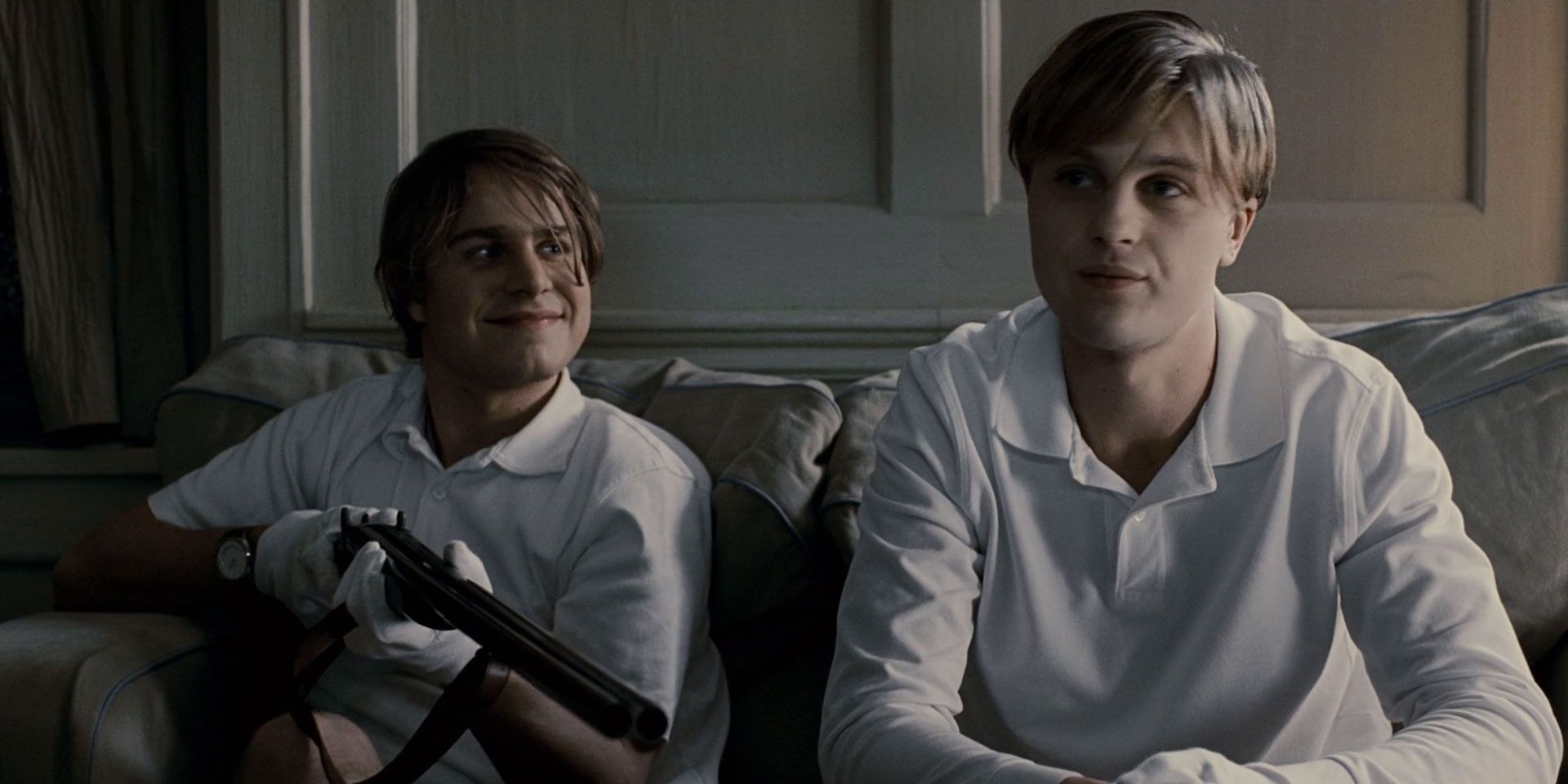 Brady Corbet and Michael Pitt sitting on the couch wearing white