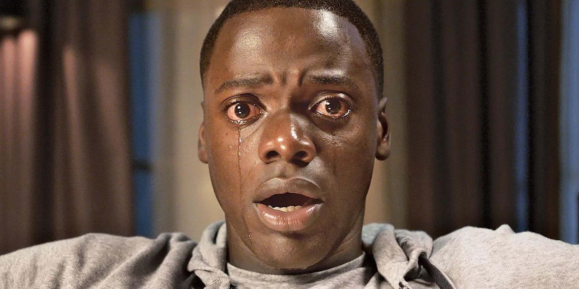 Daniel Kaluuya looking shocked and crying in Get Out.