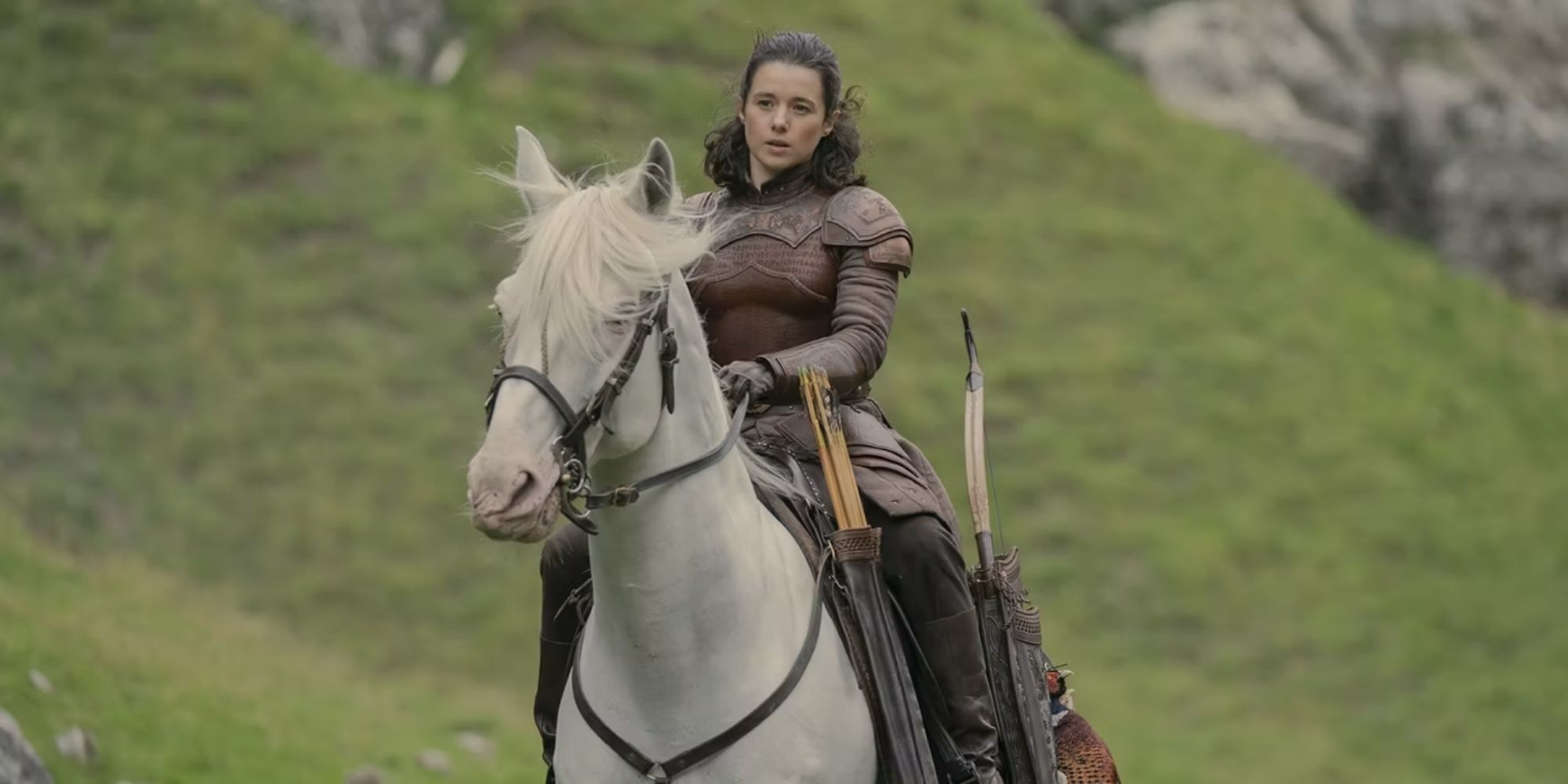 A woman wearing armor on horseback