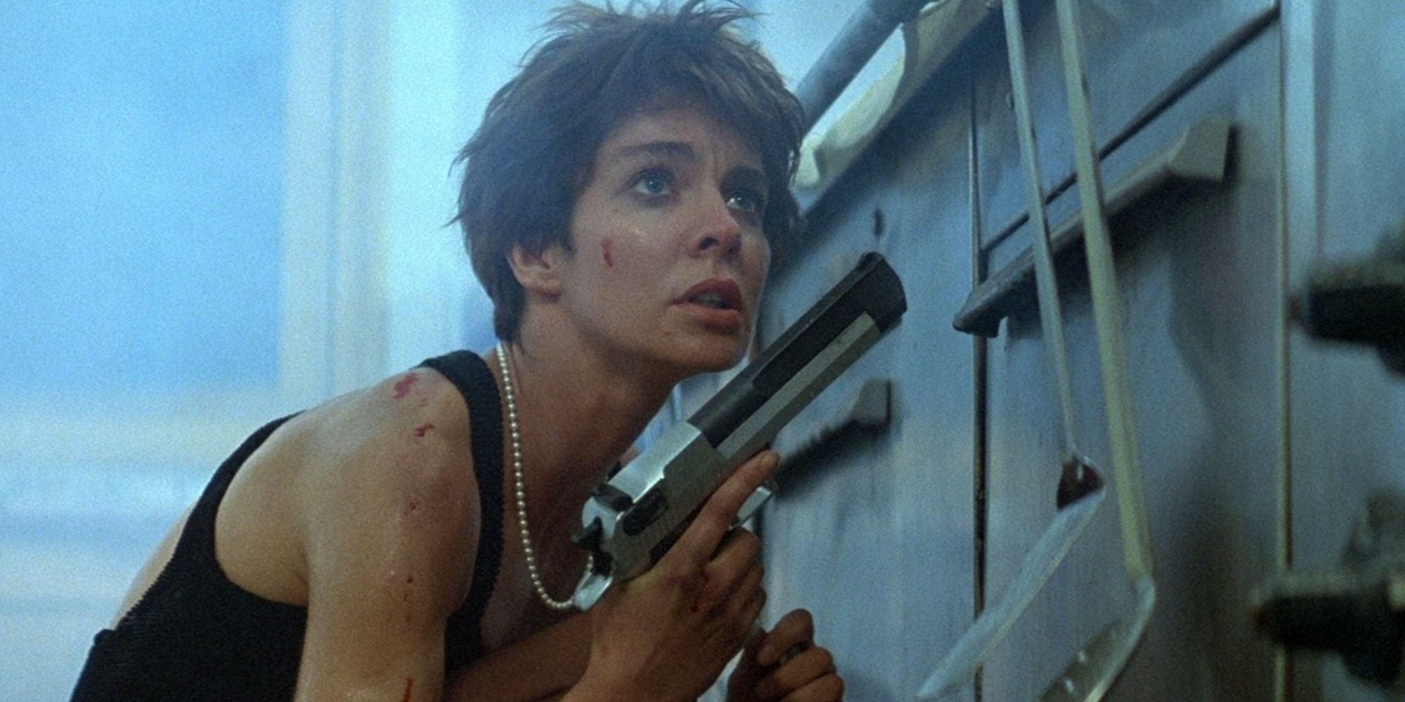 A woman hiding with a gun