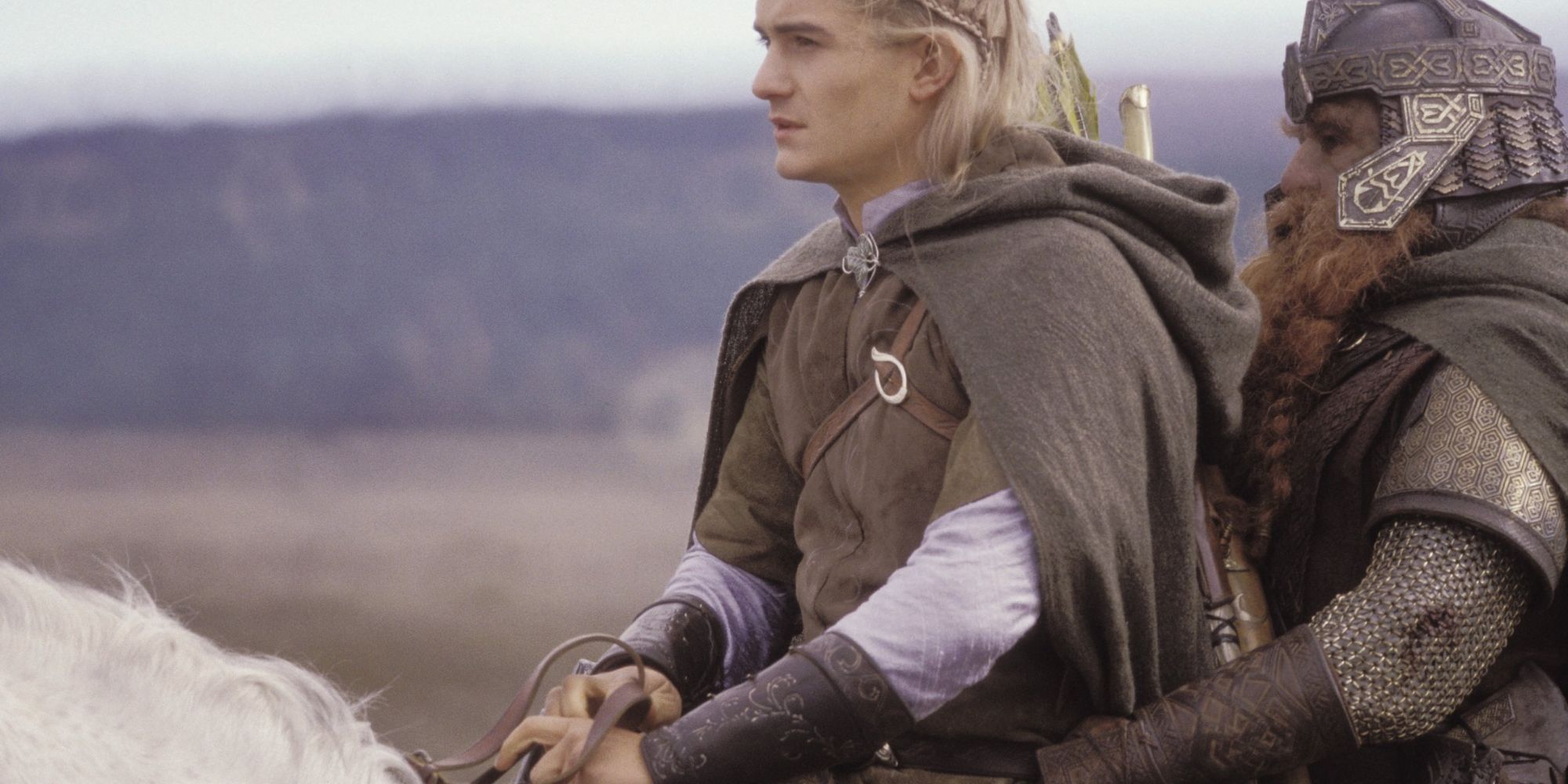 Legolas and Gimli sit atop Legolas' white horse