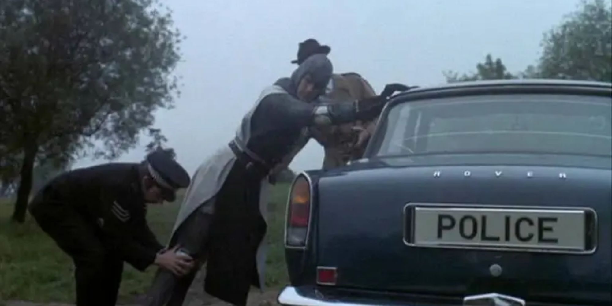 Sir Lancelot is frisked by a police officer 