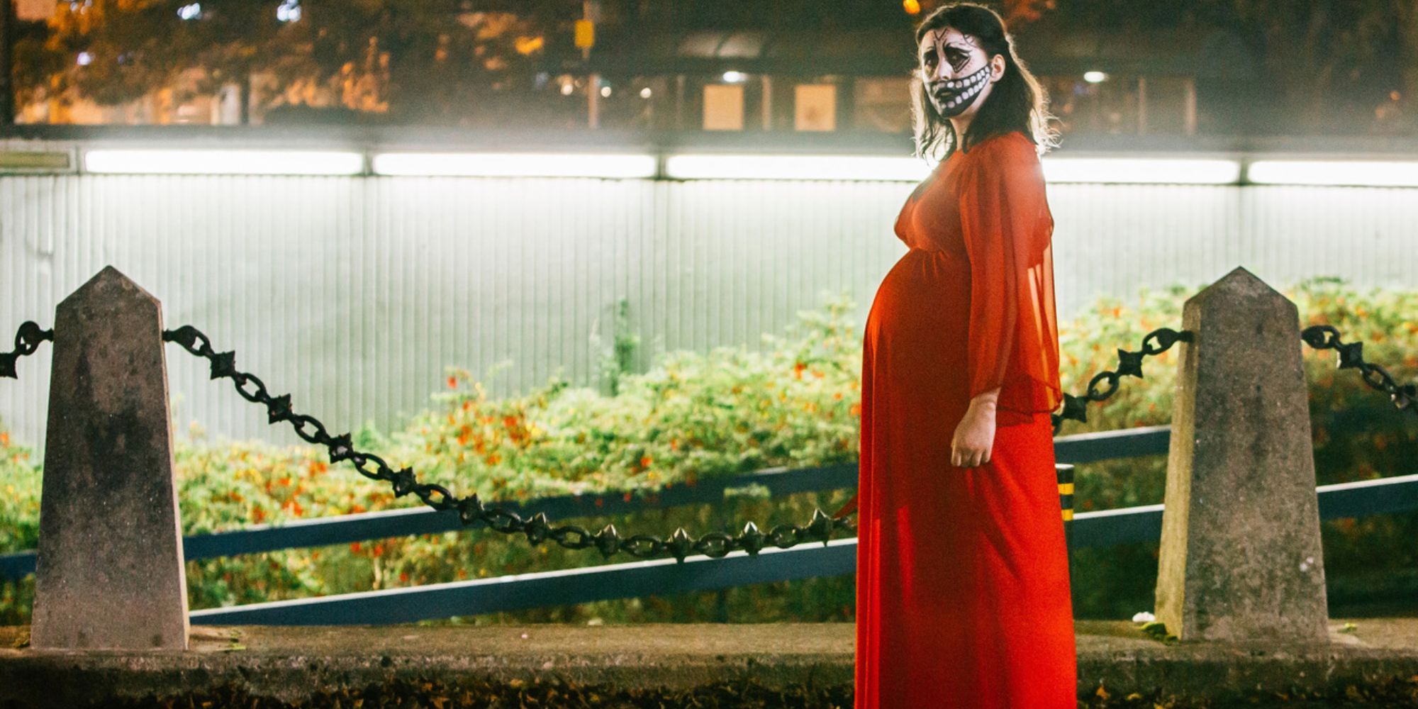 A pregnant woman in face-paint looking to the distance in Prevenge