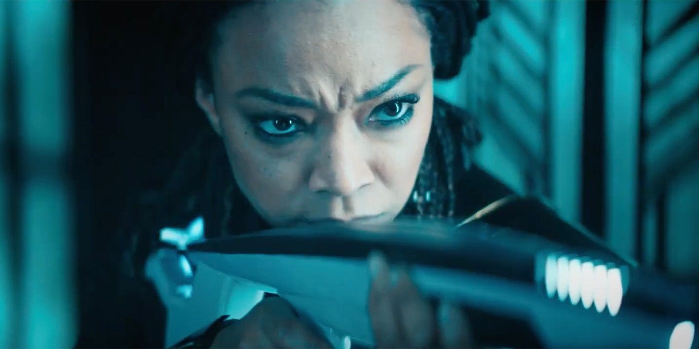 Sonequa Martin Green as Michael Burnham in a close up shot of her holding a phaser rifle in star trek discovery season 5.