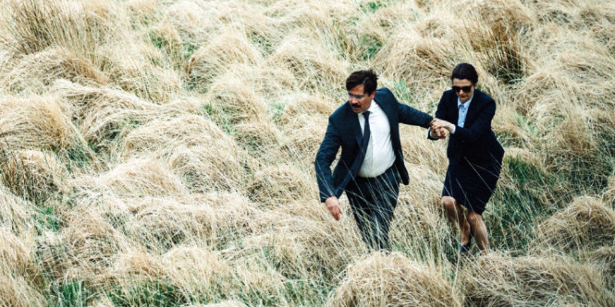 a man and a woman running through the field