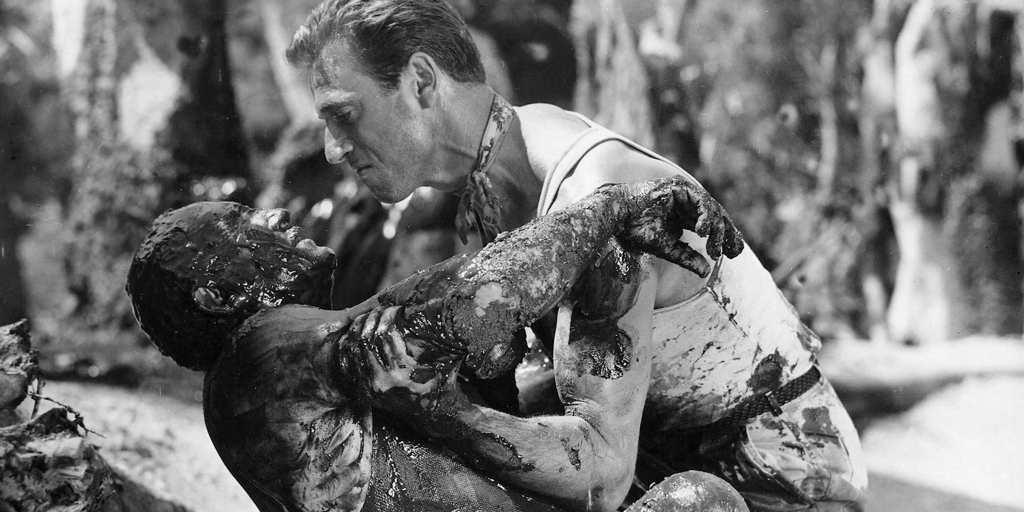 A man holding another man covered in blood in The Wages of Fear.