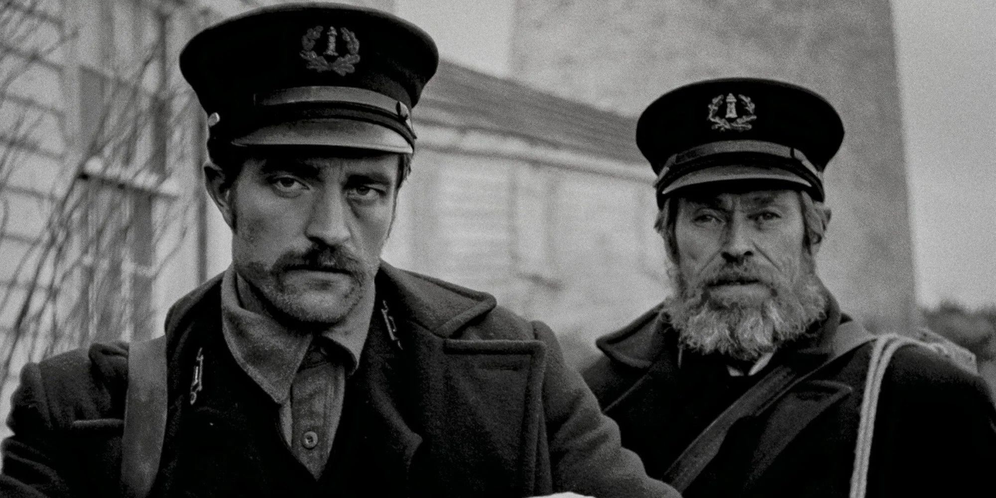 Close-up of Ephraim Winslow (Robert Pattinson) and Thomas Wake (Willem Dafoe) from 'The Lighthouse'