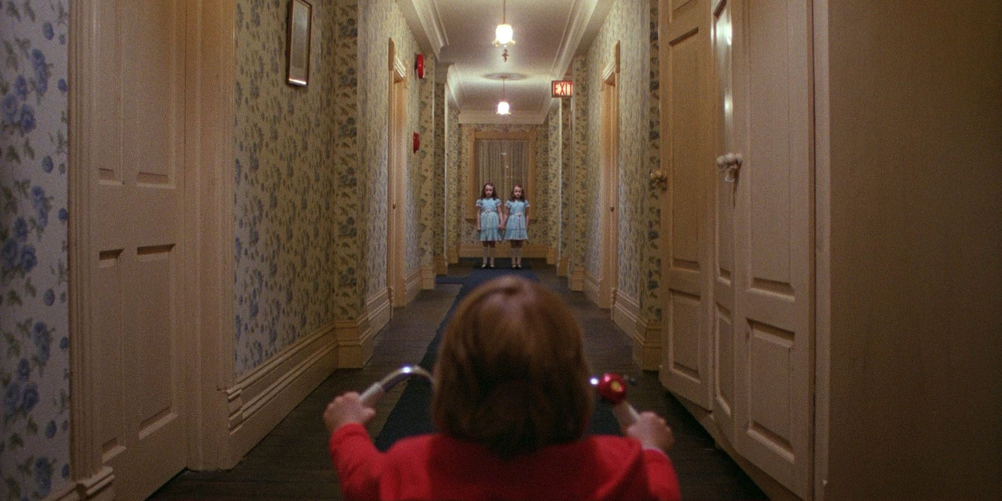 Danny looking at the twins in a hall of the Overlook Hotel from 'The Shining'