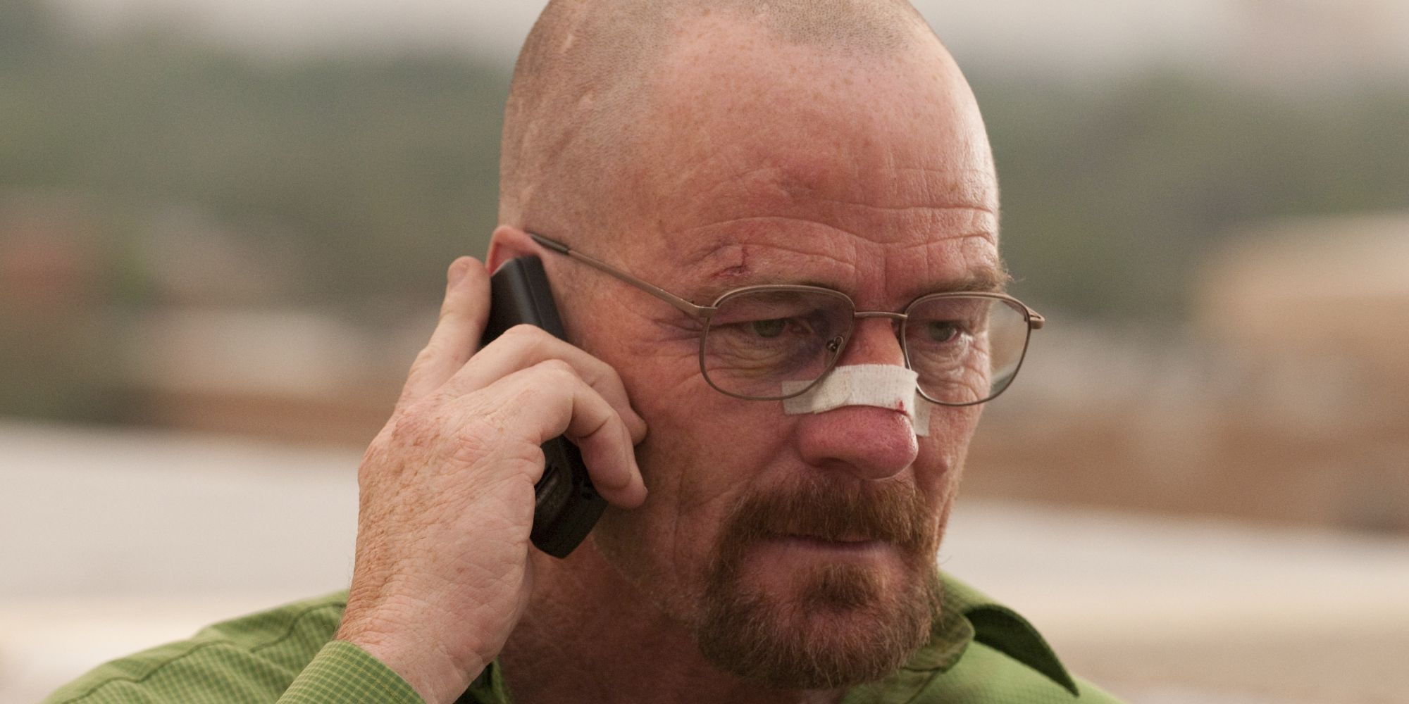 Close up on a man with broken nose talking on the phone