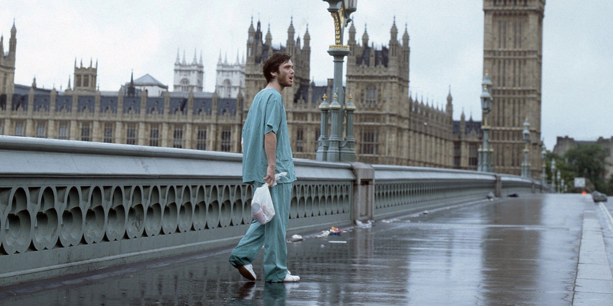 Jim in a hospital gown standing next to Big Ben in a deserted London in 28 Days Later