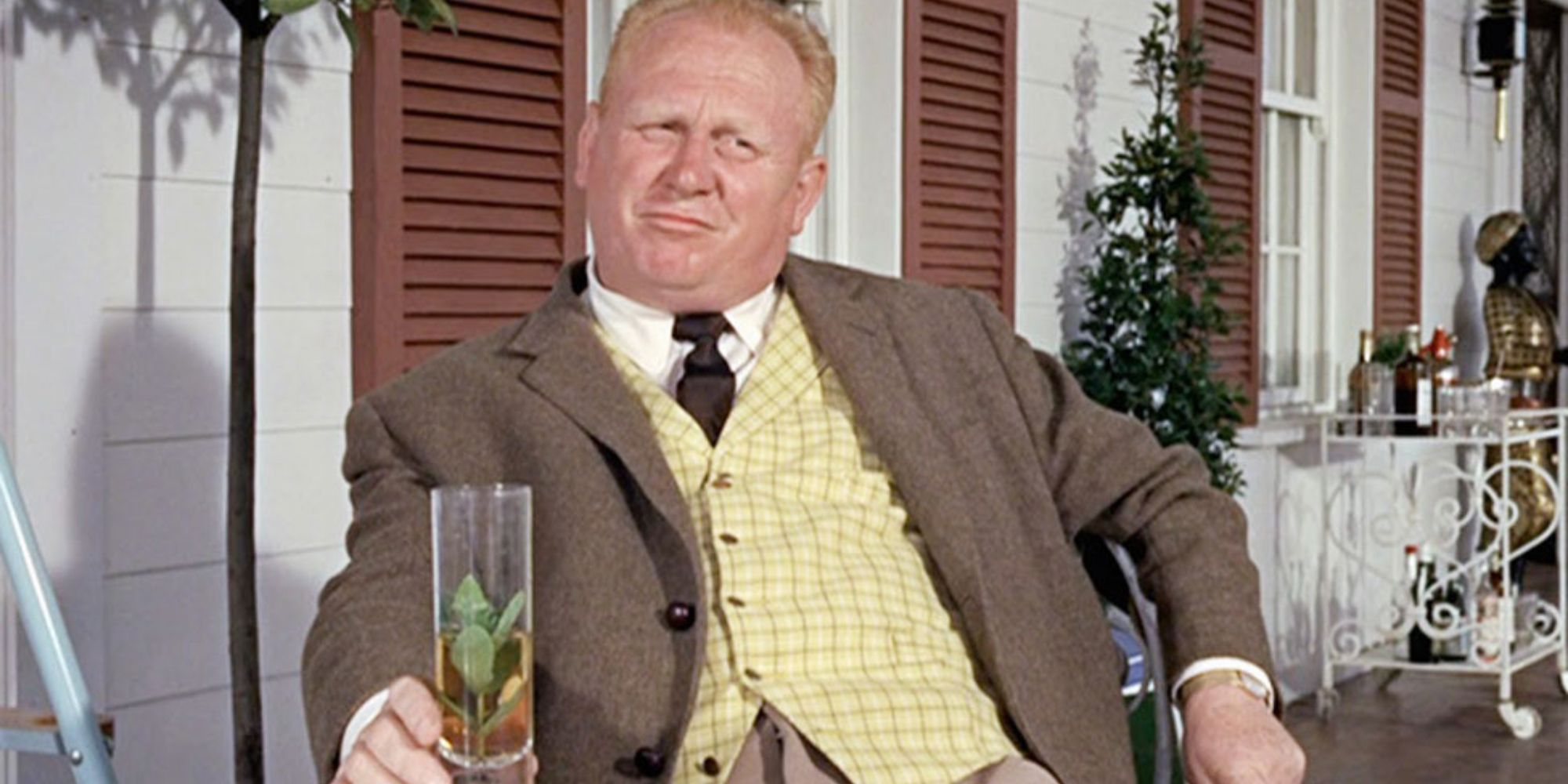 Auric Goldfinger smiling while drinking a beer in 'Goldfinger' (1964)