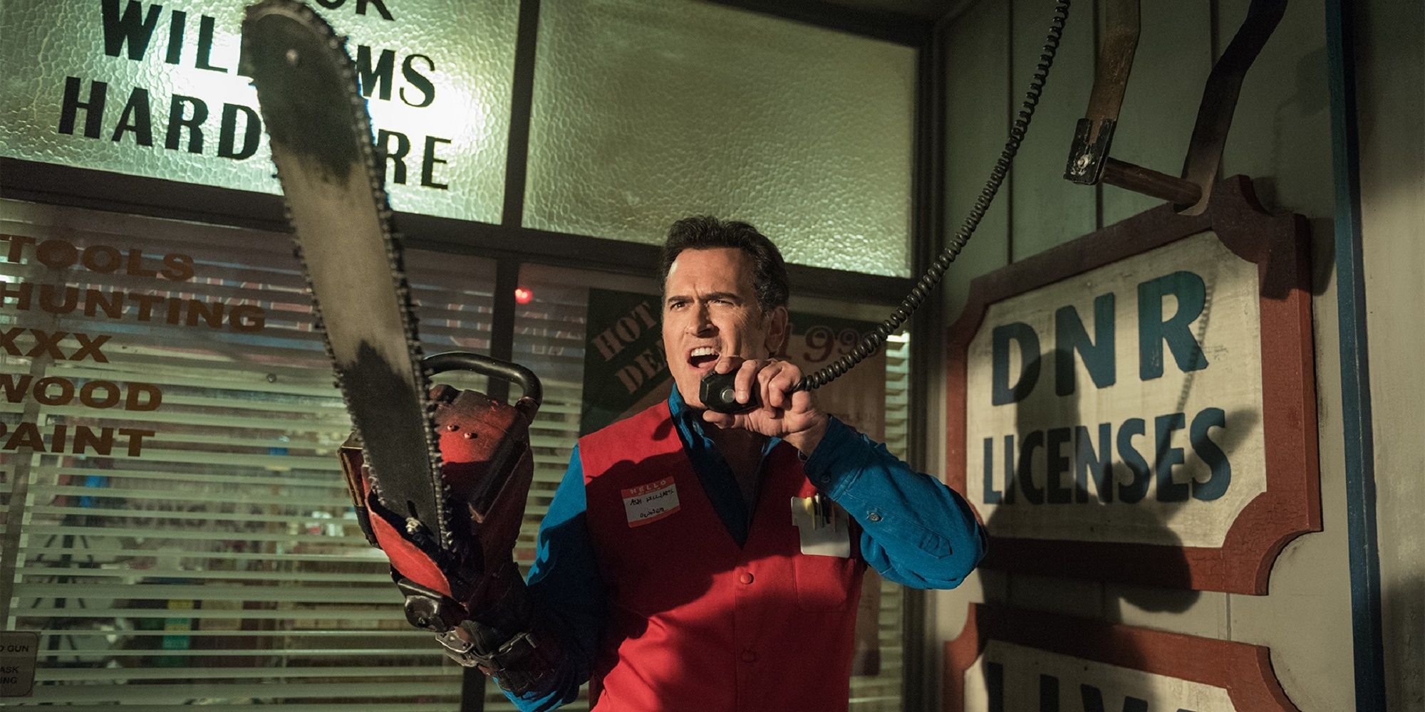 Bruce Campbell wielding a chainsaw and talking on the phone in 'Black Friday'.