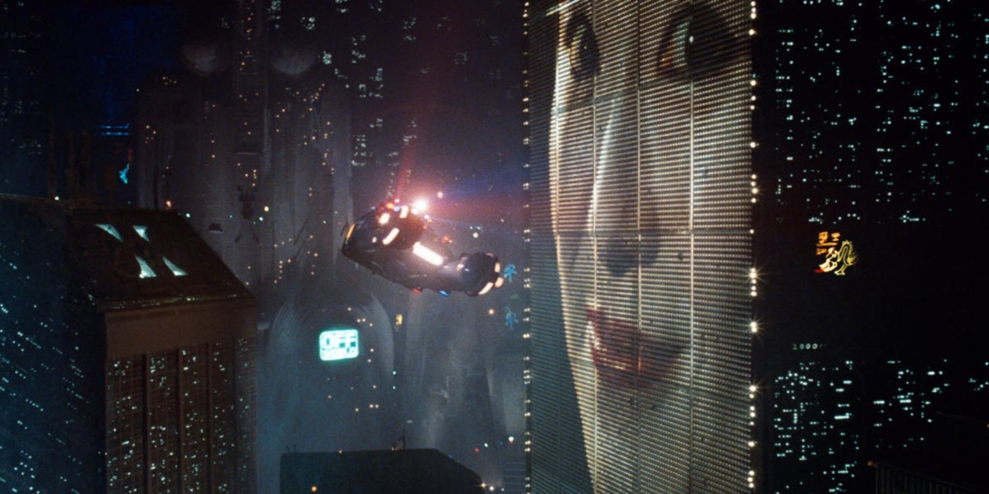 A woman smiles on an electronic display in a cityscape of 'Blade Runner'