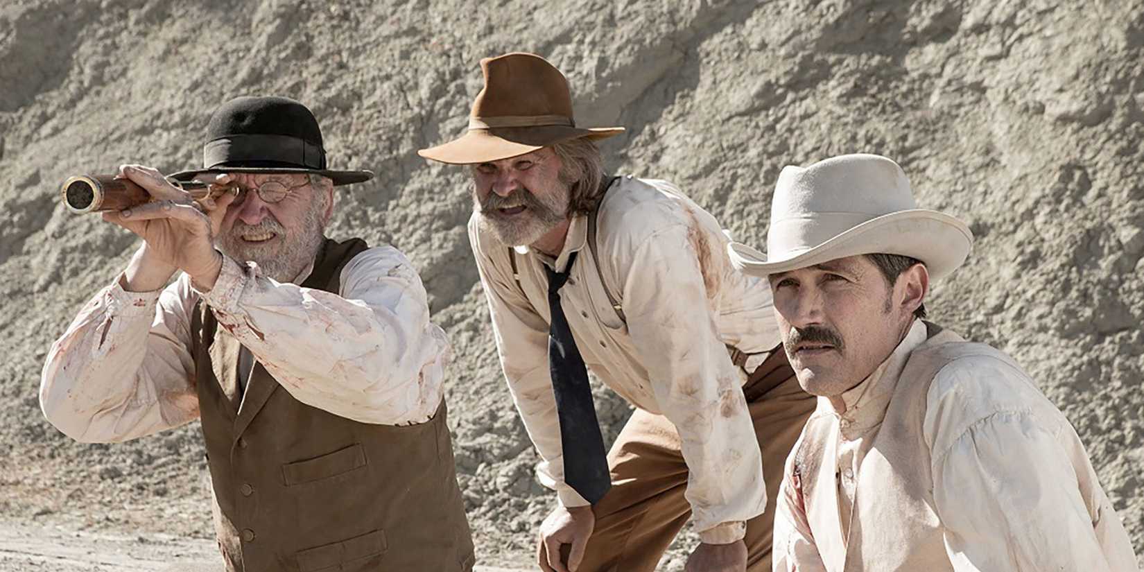 Richard Jenkins, Kurt Russell and Matthew Fox as as Deputy Chicory, Sheriff Franklin Hunt, and John Brooder looking into the distance while sitting in a valley in the film Bone Tomahawk