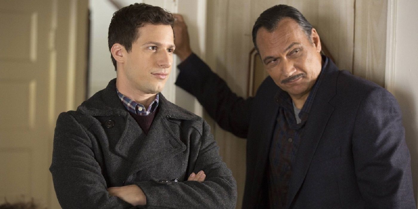 Andy Samberg & Jimmy Smits in jackets looking suspiciously at something off camera in Brooklyn Nine-Nine.