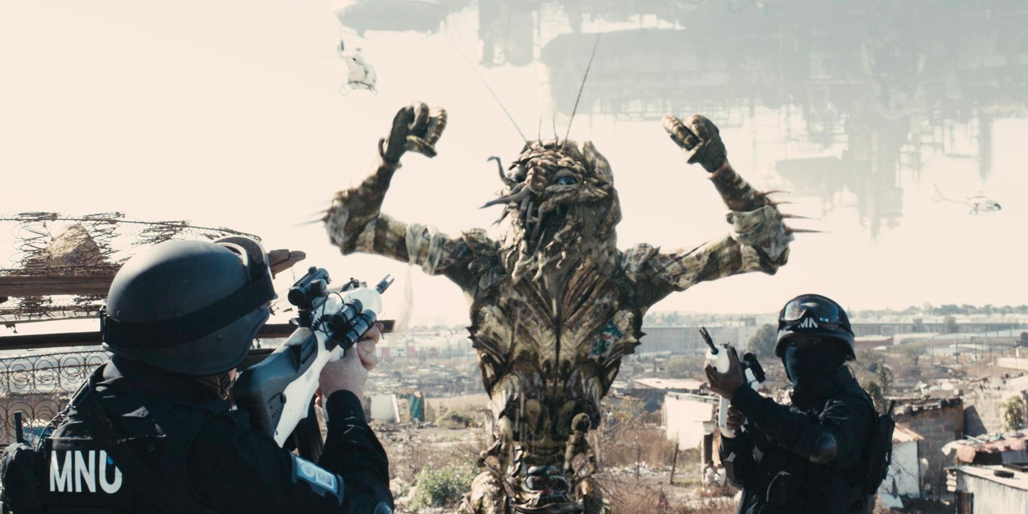 Two soldiers pointing their guns at an alien in District 9 