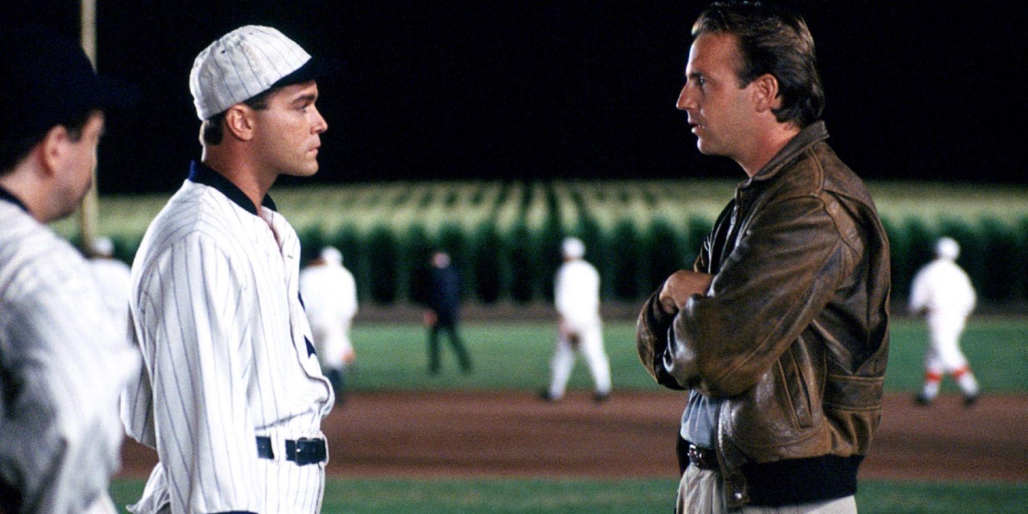 Kevin Costner and Ray Liotta as Ray Kinsella and Shoeless Joe Jackson talking on the baseball field in Field of Dreams